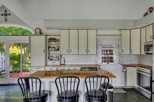 3140 State Route 5s, Danube, NY 13339 - kitchen featuring appliances with stainless steel finishes, wooden counters, and backsplash