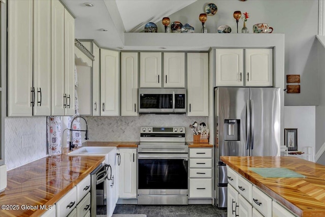 3140 State Route 5s, Danube, NY 13339 - kitchen with stainless steel appliances, wooden counters, tasteful backsplash, and white cabinetry