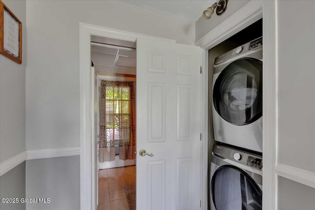 3140 State Route 5s, Danube, NY 13339 - laundry area featuring stacked washer / drying machine and light tile patterned floors