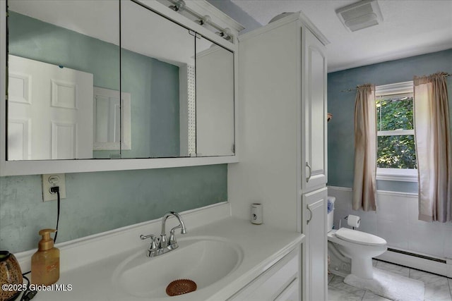 3140 State Route 5s, Danube, NY 13339 - bathroom featuring a baseboard radiator, vanity, tile walls, and marble finish flooring