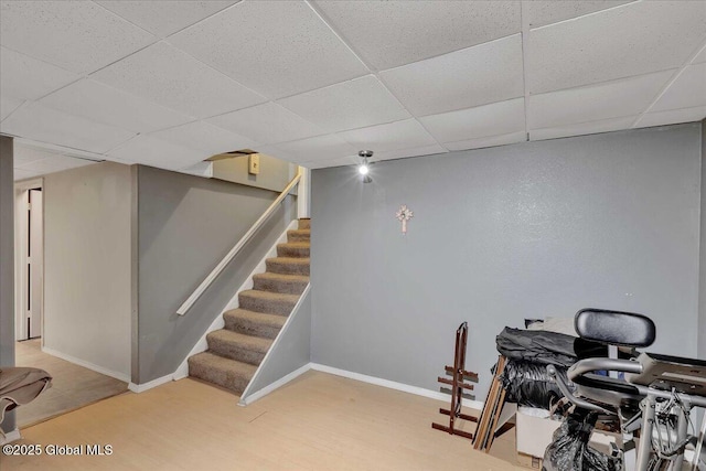 3140 State Route 5s, Danube, NY 13339 - finished below grade area featuring a paneled ceiling, stairway, and wood finished floors