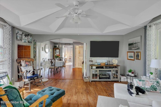 3140 State Route 5s, Danube, NY 13339 - living room with arched walkways, ceiling fan, wood finished floors, and a tray ceiling
