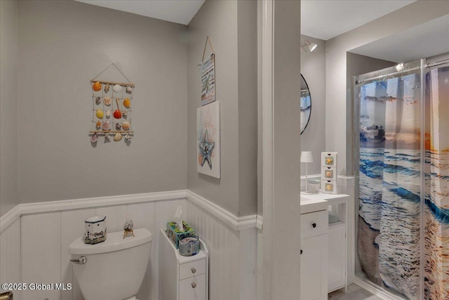 3140 State Route 5s, Danube, NY 13339 - bathroom with a wainscoted wall, vanity, a shower with shower curtain, and a decorative wall