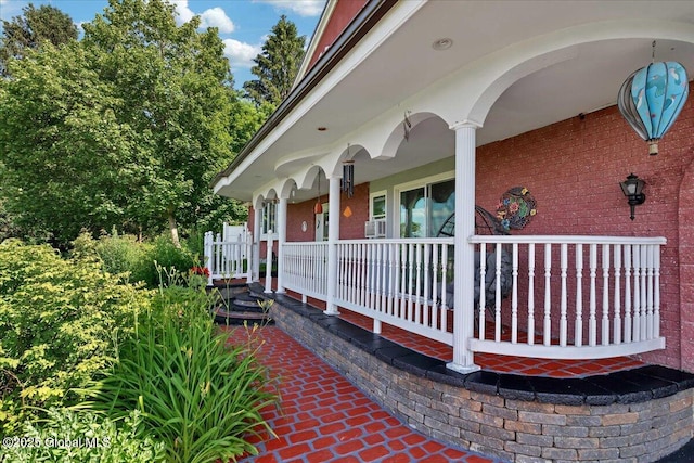 3140 State Route 5s, Danube, NY 13339 - doorway to property with covered porch, brick siding, and cooling unit