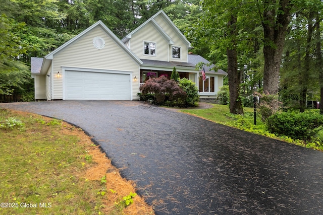 69 Deer Run Holw, Halfmoon, NY 12065 - traditional home with driveway, an attached garage, and a shingled roof
