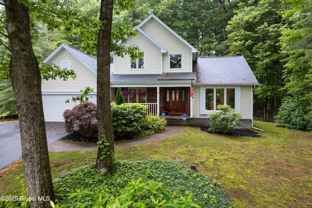 69 Deer Run Holw, Halfmoon, NY 12065 - traditional-style home featuring a porch, a garage, a front lawn, and roof with shingles