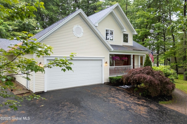 69 Deer Run Holw, Halfmoon, NY 12065 - traditional-style house featuring driveway, covered porch, roof with shingles, and a garage
