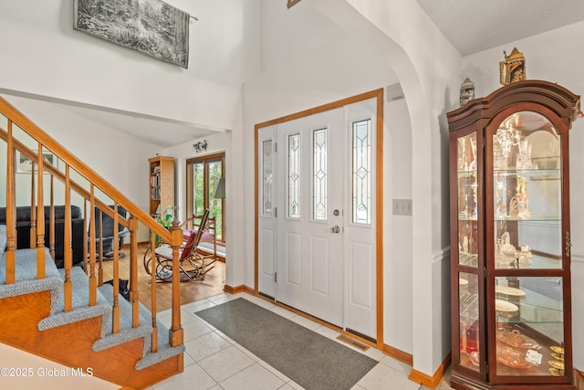 69 Deer Run Holw, Halfmoon, NY 12065 - foyer entrance with arched walkways, tile patterned flooring, and stairs