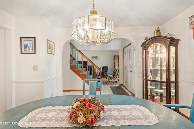69 Deer Run Holw, Halfmoon, NY 12065 - dining room with arched walkways, tile patterned flooring, a chandelier, and stairs