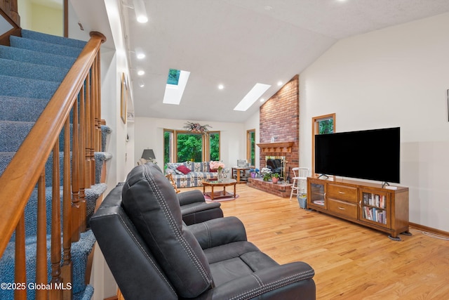 69 Deer Run Holw, Halfmoon, NY 12065 - living area featuring a skylight, light wood-type flooring, recessed lighting, a fireplace, and stairs