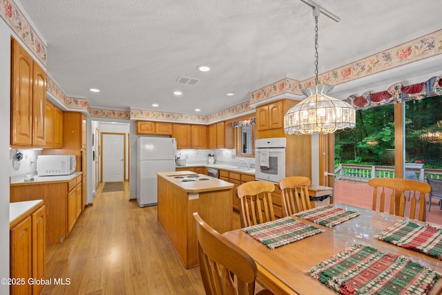 69 Deer Run Holw, Halfmoon, NY 12065 - dining space with light wood-style floors, a textured ceiling, and a chandelier
