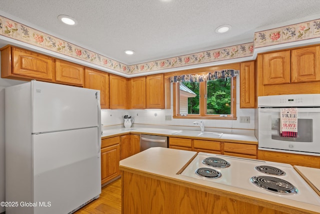 69 Deer Run Holw, Halfmoon, NY 12065 - kitchen featuring white appliances, a textured ceiling, light countertops, light wood-style floors, and backsplash