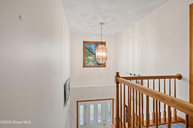69 Deer Run Holw, Halfmoon, NY 12065 - staircase featuring a chandelier, a textured ceiling, and a towering ceiling