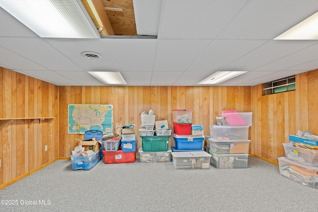 69 Deer Run Holw, Halfmoon, NY 12065 - finished basement with a drop ceiling, carpet flooring, and wood walls