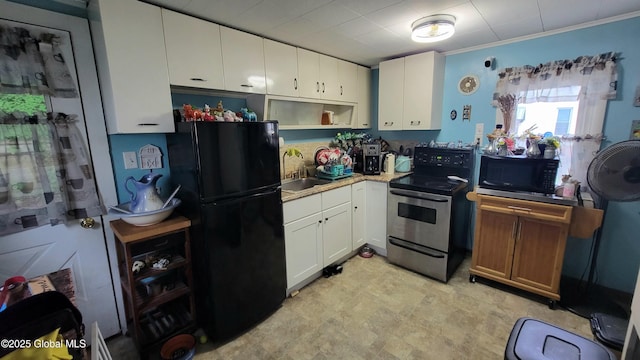 52 Hancock St, Fort Plain, NY 13339 - kitchen with stainless steel range with electric stovetop, freestanding refrigerator, white cabinets, light countertops, and open shelves