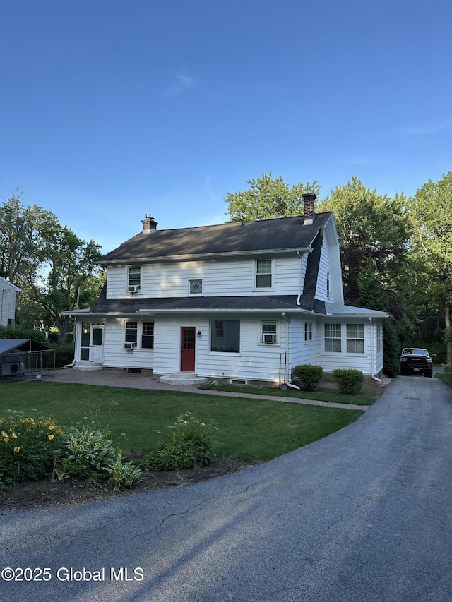 945 Morgan Ave, Niskayuna, NY 12309 - view of front of house with a chimney, a front yard, and asphalt driveway