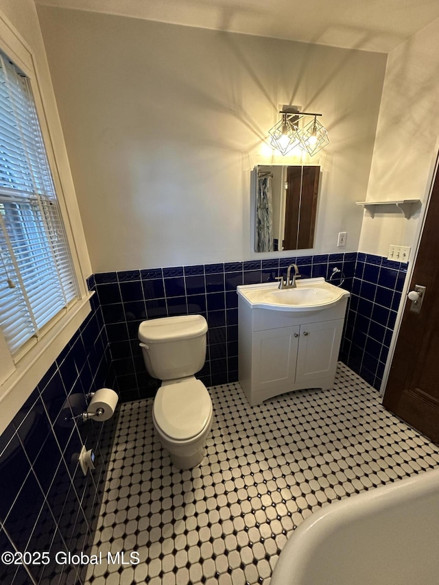 945 Morgan Ave, Niskayuna, NY 12309 - bathroom featuring tile walls, wainscoting, and vanity
