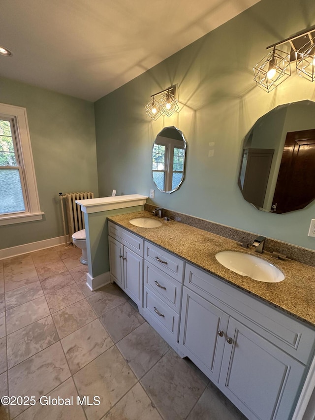 945 Morgan Ave, Niskayuna, NY 12309 - full bath with double vanity, radiator heating unit, and marble look tile flooring