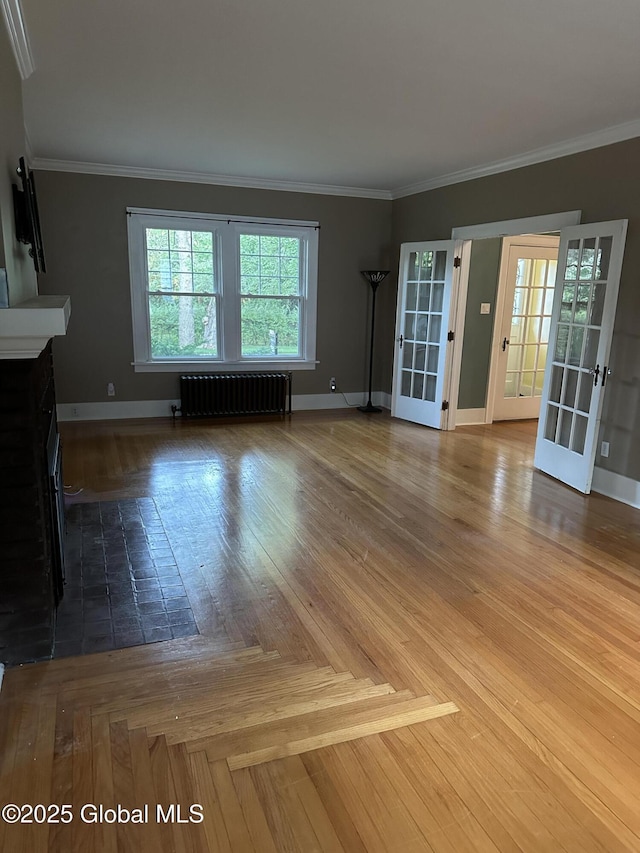 945 Morgan Ave, Niskayuna, NY 12309 - unfurnished living room featuring radiator heating unit, french doors, a fireplace with flush hearth, and ornamental molding