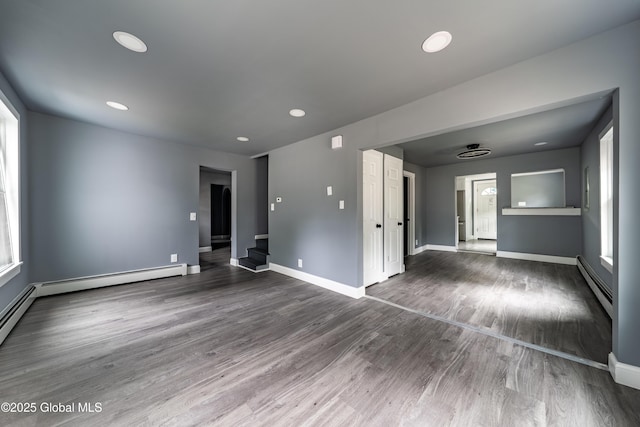 92 Central Ave, Rensselaer, NY 12144 - unfurnished room featuring a baseboard heating unit, plenty of natural light, wood finished floors, and recessed lighting