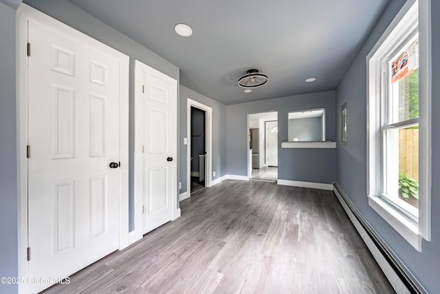 92 Central Ave, Rensselaer, NY 12144 - spare room with a baseboard heating unit, wood finished floors, and recessed lighting