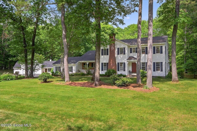 6 Leaward Way, Saratoga Springs, NY 12866 - colonial-style house with a chimney, a front lawn, and view of scattered trees