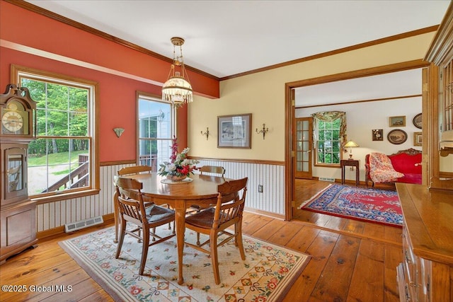 6 Leaward Way, Saratoga Springs, NY 12866 - dining room featuring a wainscoted wall, light wood-style floors, a chandelier, and crown molding