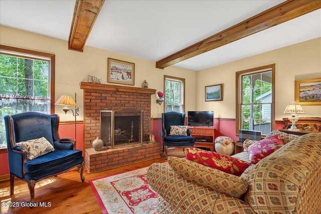 6 Leaward Way, Saratoga Springs, NY 12866 - living area featuring wood finished floors, plenty of natural light, a fireplace, and beam ceiling