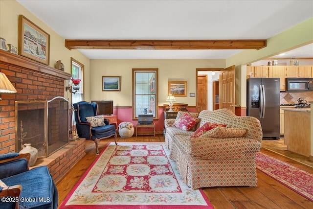 6 Leaward Way, Saratoga Springs, NY 12866 - living room featuring hardwood / wood-style flooring, a brick fireplace, and beam ceiling