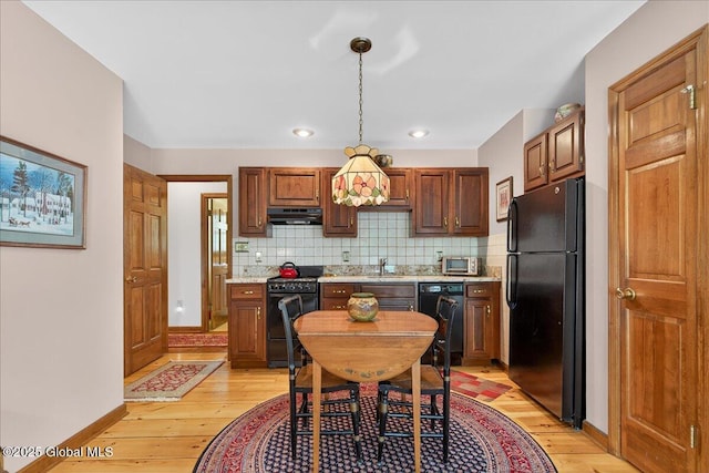 6 Leaward Way, Saratoga Springs, NY 12866 - kitchen with black appliances, under cabinet range hood, light wood-style flooring, and decorative backsplash