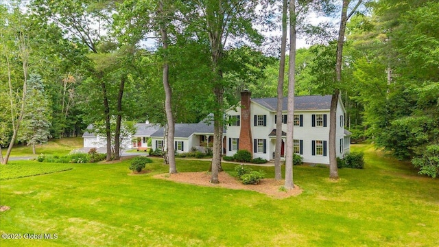 6 Leaward Way, Saratoga Springs, NY 12866 - colonial house featuring a chimney, a front lawn, and view of scattered trees