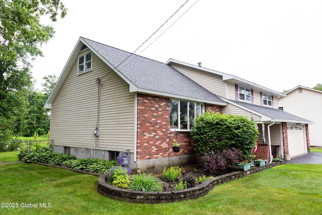 46 Cindy Crest Dr, Rotterdam, NY 12306 - view of side of home featuring roof with shingles, brick siding, asphalt driveway, and a garage
