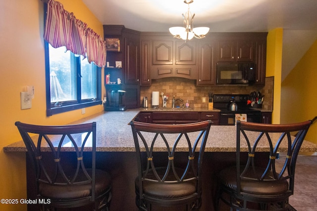46 Cindy Crest Dr, Rotterdam, NY 12306 - kitchen with black appliances, a chandelier, backsplash, a peninsula, and light countertops