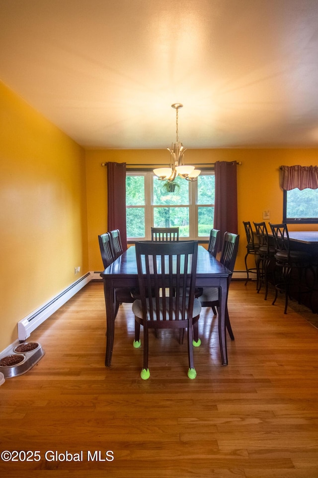 46 Cindy Crest Dr, Rotterdam, NY 12306 - dining space featuring baseboard heating, light wood finished floors, healthy amount of natural light, and a chandelier
