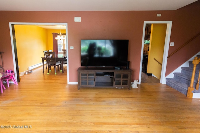 46 Cindy Crest Dr, Rotterdam, NY 12306 - living room with wood finished floors, a chandelier, and stairway