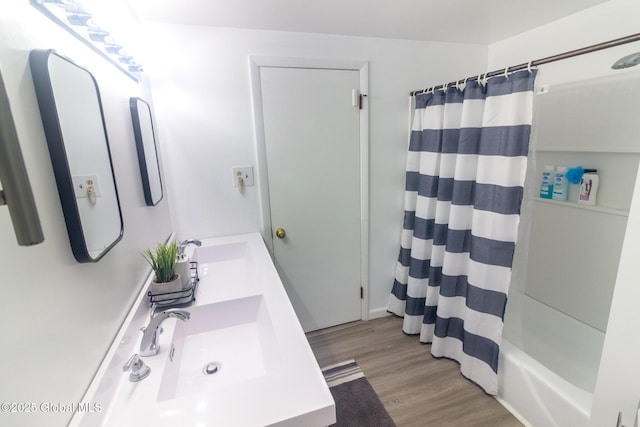 46 Cindy Crest Dr, Rotterdam, NY 12306 - full bath with wood finished floors, double vanity, and shower / bath combo with shower curtain