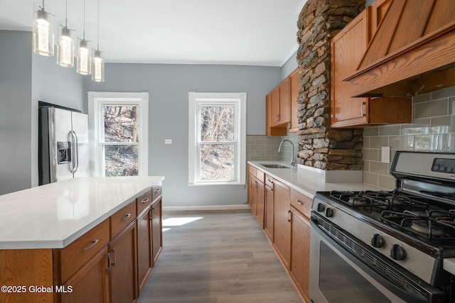 55 Spring Ave, Troy, NY 12180 - kitchen featuring stainless steel appliances, premium range hood, brown cabinetry, and crown molding