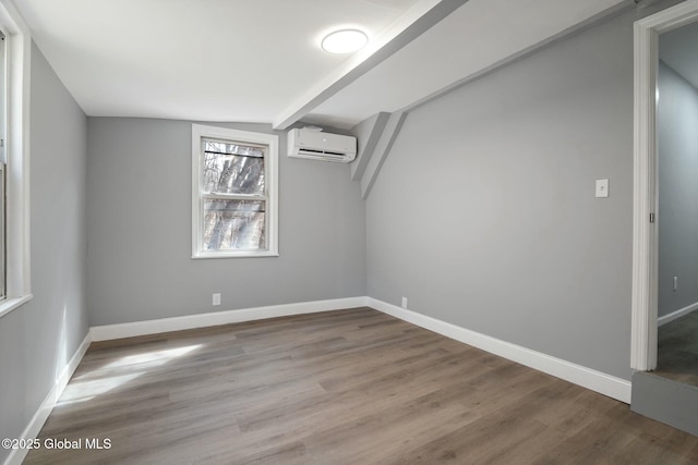 55 Spring Ave, Troy, NY 12180 - unfurnished room featuring a wall mounted AC, vaulted ceiling, and wood finished floors