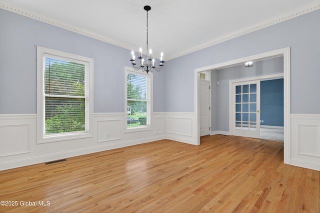 10 Sweetbriar Dr, Wilton, NY 12831 - spare room with a chandelier, wainscoting, light wood-style floors, crown molding, and french doors