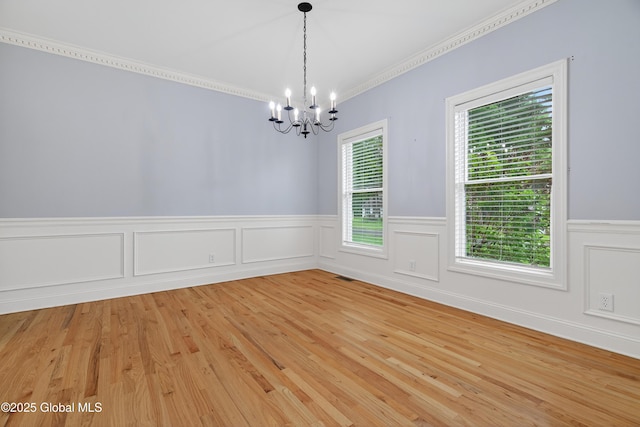 10 Sweetbriar Dr, Wilton, NY 12831 - unfurnished room with a chandelier, wainscoting, light wood-style floors, and crown molding