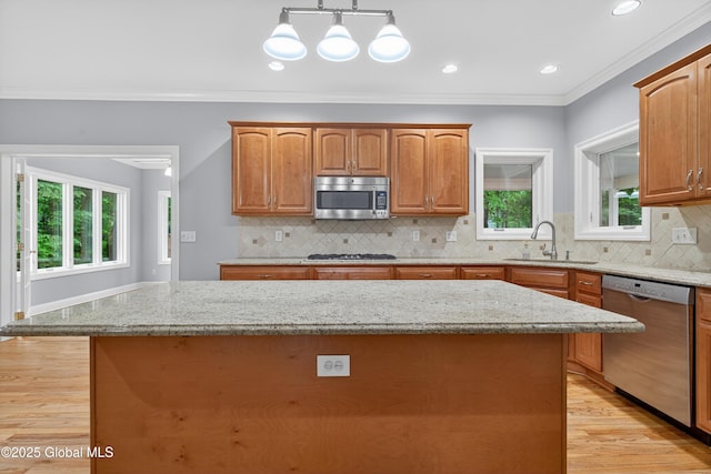 10 Sweetbriar Dr, Wilton, NY 12831 - kitchen with appliances with stainless steel finishes, light wood finished floors, light stone countertops, plenty of natural light, and ornamental molding