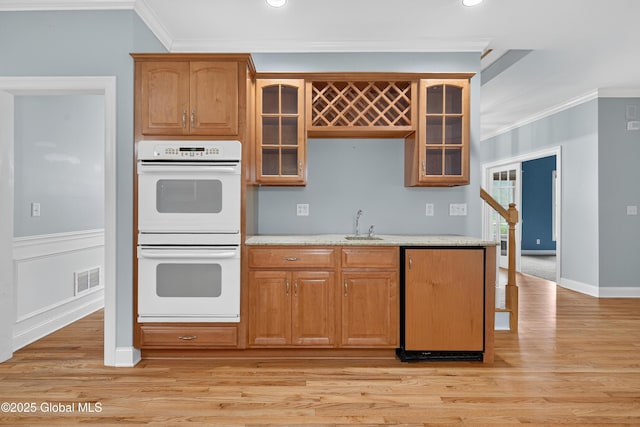 10 Sweetbriar Dr, Wilton, NY 12831 - kitchen featuring double oven, ornamental molding, light wood finished floors, glass insert cabinets, and recessed lighting