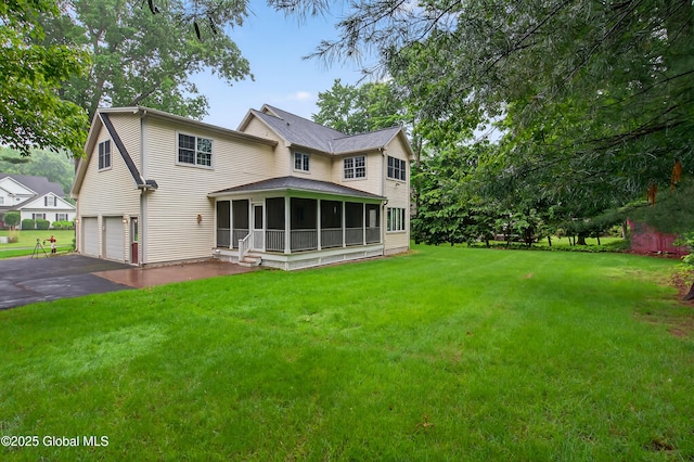 10 Sweetbriar Dr, Wilton, NY 12831 - rear view of house featuring an attached garage, a sunroom, asphalt driveway, and a yard