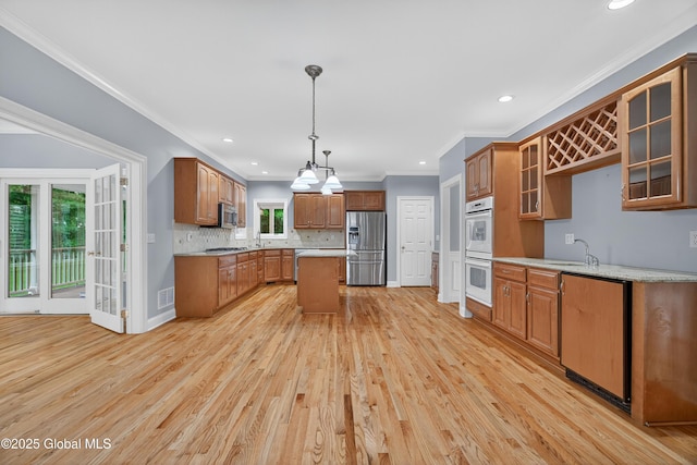 10 Sweetbriar Dr, Wilton, NY 12831 - kitchen with stainless steel appliances, recessed lighting, light wood-style flooring, backsplash, and glass insert cabinets