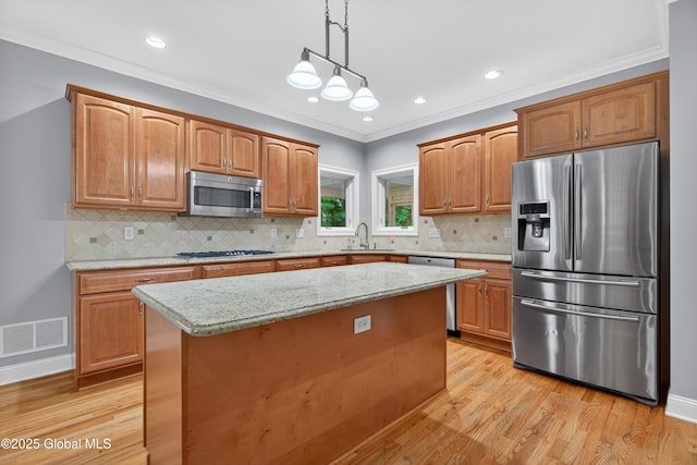 10 Sweetbriar Dr, Wilton, NY 12831 - kitchen featuring appliances with stainless steel finishes, light wood-style floors, a center island, pendant lighting, and light stone countertops