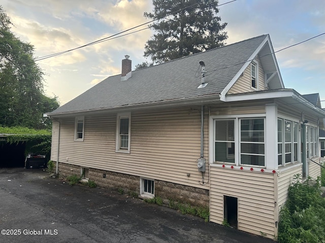 7 Frost Pl, Albany, NY 12205 - view of side of home featuring a chimney and a shingled roof
