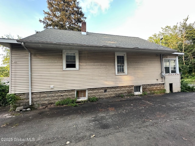 7 Frost Pl, Albany, NY 12205 - view of side of property with a chimney and a shingled roof
