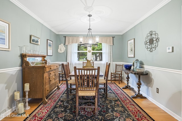6458 Vosburgh Rd, Guilderland, NY 12009 - dining space with a chandelier, wood finished floors, and crown molding