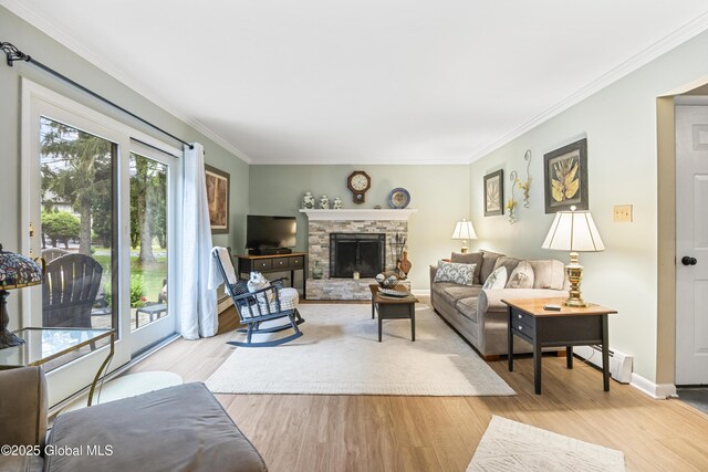 6458 Vosburgh Rd, Guilderland, NY 12009 - living area featuring wood finished floors, ornamental molding, baseboard heating, and a stone fireplace