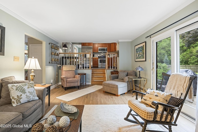 6458 Vosburgh Rd, Guilderland, NY 12009 - living area with ornamental molding, stairway, and light wood-style floors